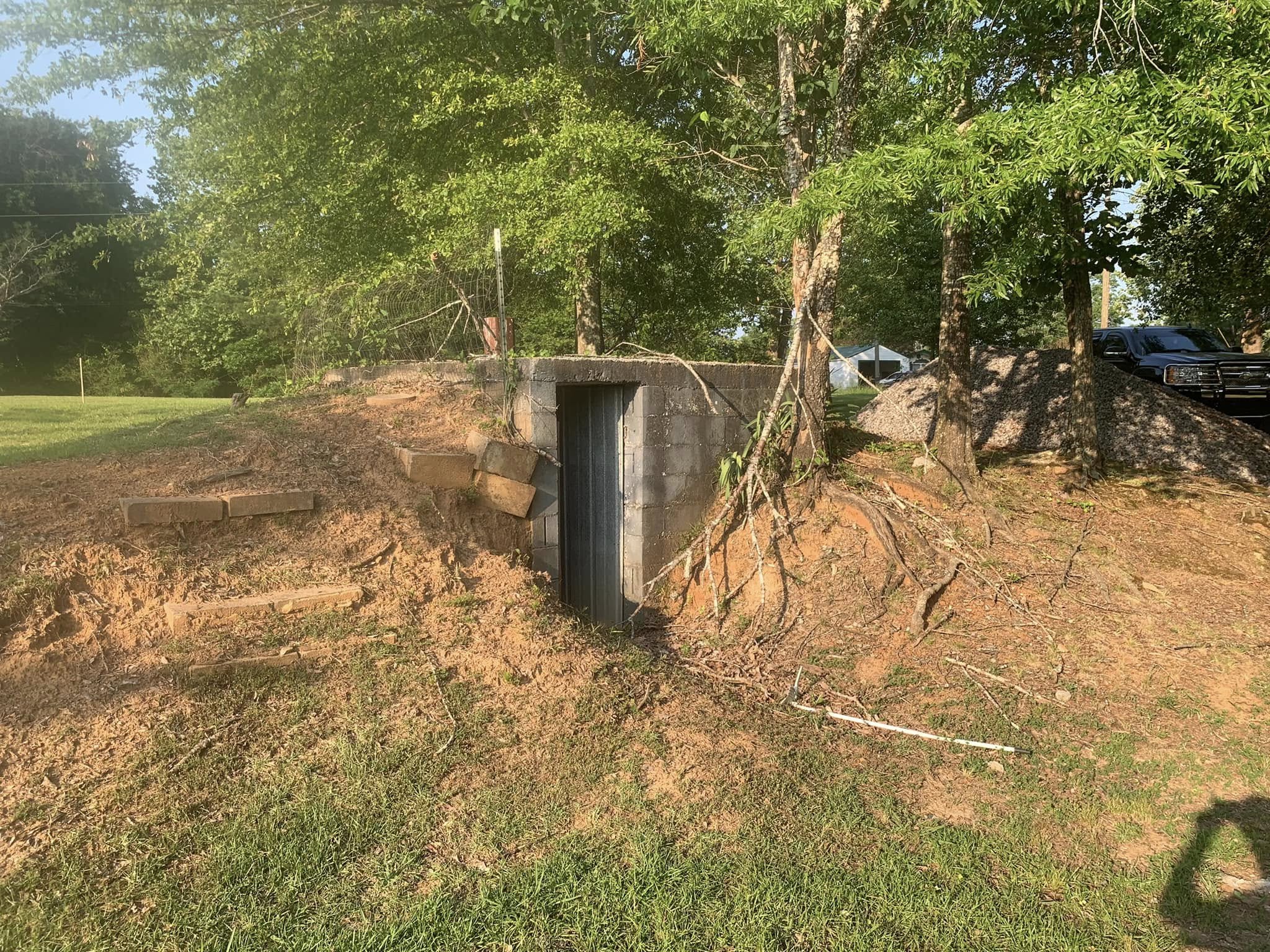 Excavator preparing a level building pad in Cullman County, AL