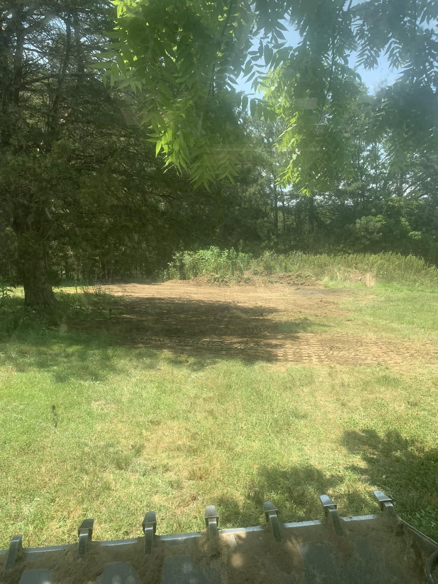 Bulldozer grading and leveling farmland in Cullman County, AL